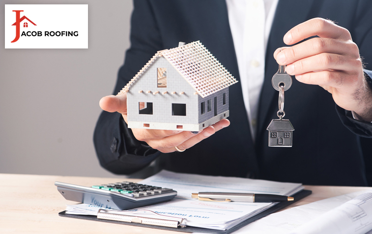 Man holding a key symbolizing new homeownership and the importance of roof certification.